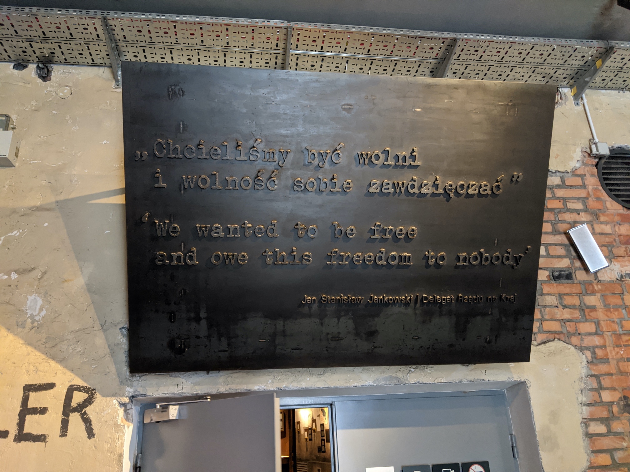sign over the entrance to the warsaw uprising museum